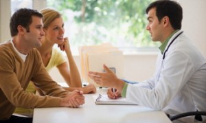 USA, New Jersey, Jersey City, Couple receiving advice from doctor in office